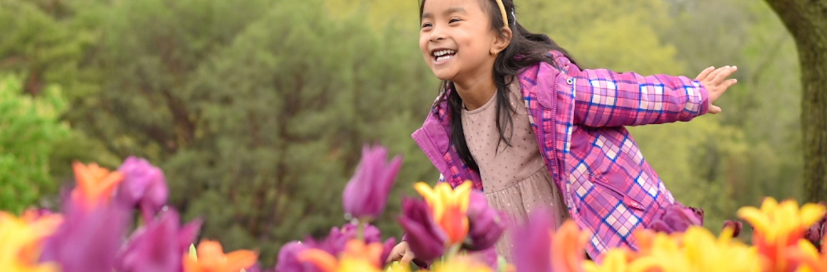 Child running through the tulips