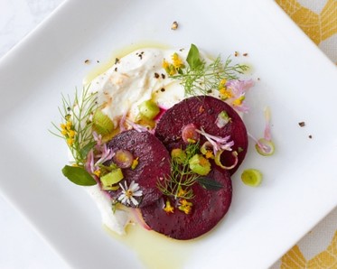 plate with beets and edible blossoms