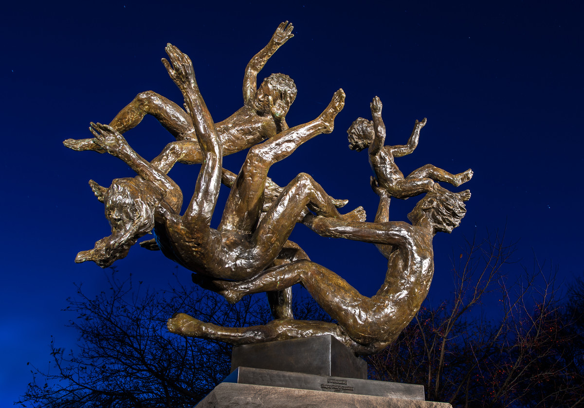Swimmers sculpture at night