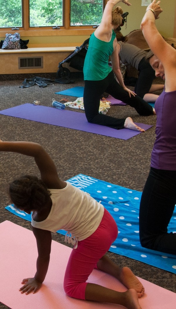 Kid and parents doing yoga