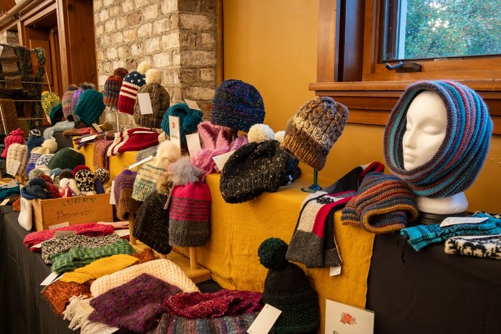 Handmade hats and gloves on a table